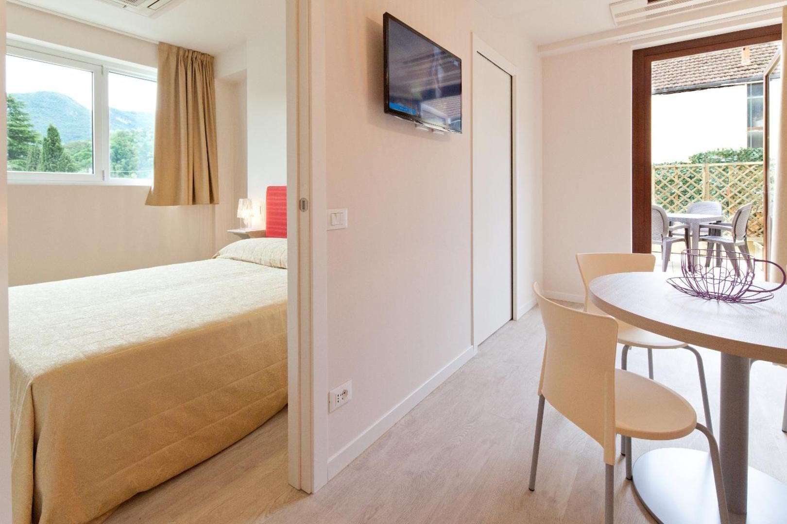 Residence Lenno – studio modern cu zona de dormit si masa dining, usa spre balcon cu vedere la munte, Lenno Residence Lenno – studio modern cu zona de dormit si masa dining, usa spre balcon cu vedere la munte, Lenno