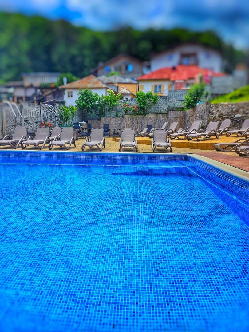 Hotel Select Băile Olănești – piscina exterioară cu șezlonguri și umbrele Hotel Select Băile Olănești – piscina exterioară cu șezlonguri și umbrele